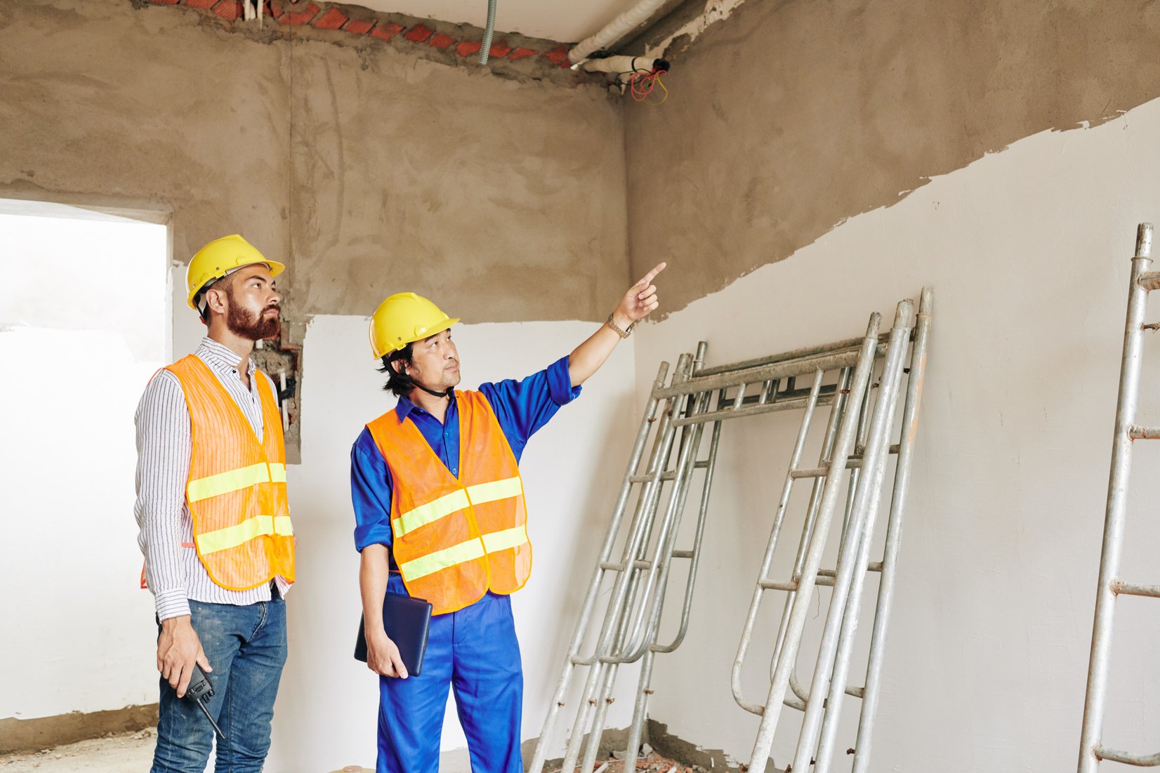 Builders Discussing Leaking Roof